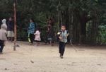 Kids playing a traditional top spinning game in Laos