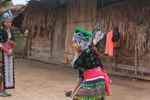 Hmong girl in traditional garb talking on a cell phone