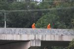 Monks on a bridge using cell phones