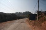 Road-straddling village in Laos, many villages have been relocated closer to new roads